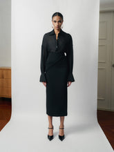 Tailored high-waisted skirt with side-wrap detail and midi silhouette